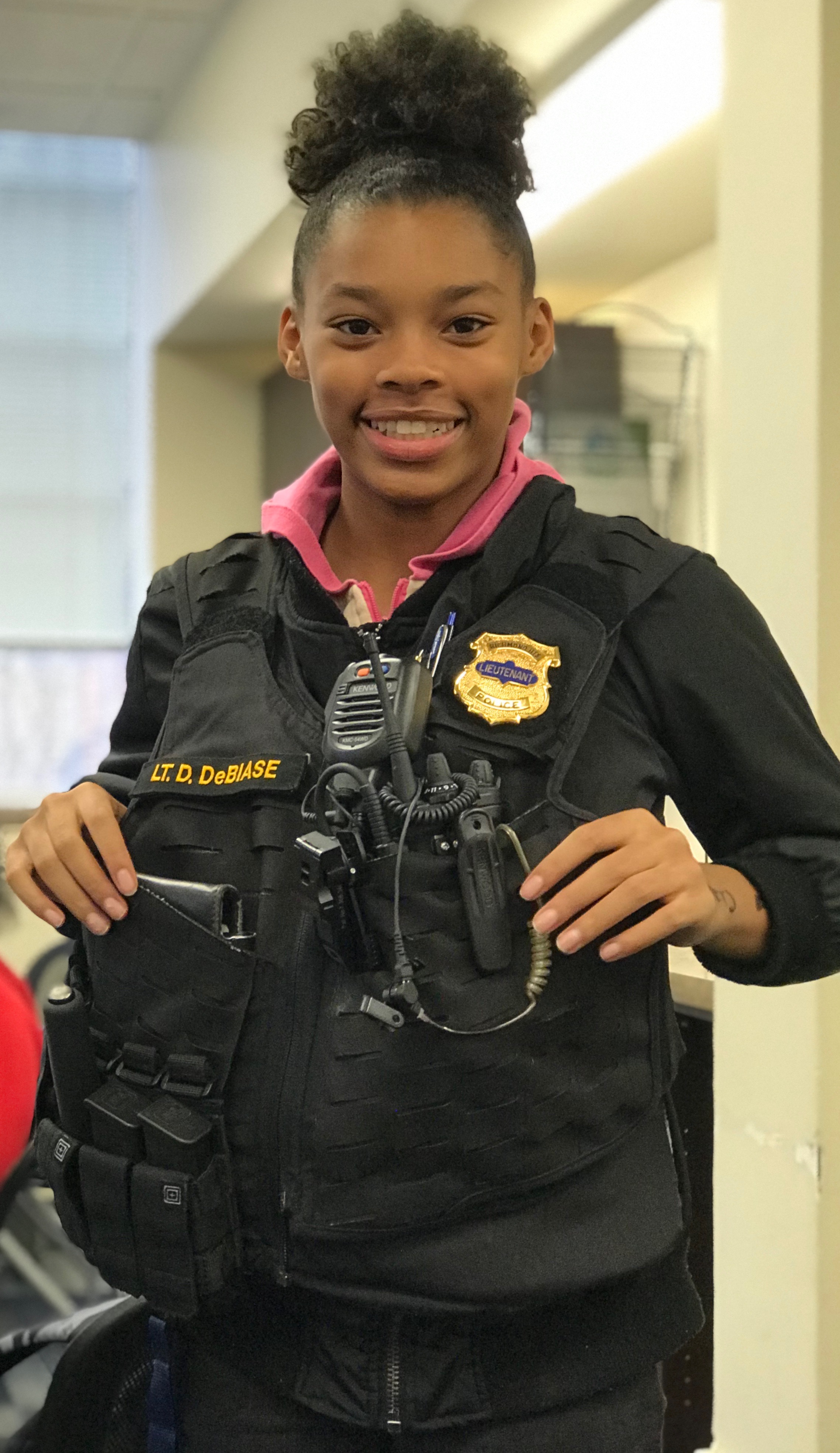 Richmond Heights Elementary student Amari Cloud tries on Lt. Denise DeBiase’s vest. Photo courtesy of Richmond Heights Police Department